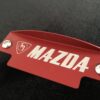 Red M Mazda fly wheel cover
