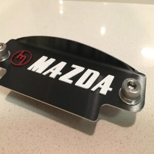Red M White Mazda black plate 12a
