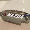 Red M white Mazda 12a flywheel cover