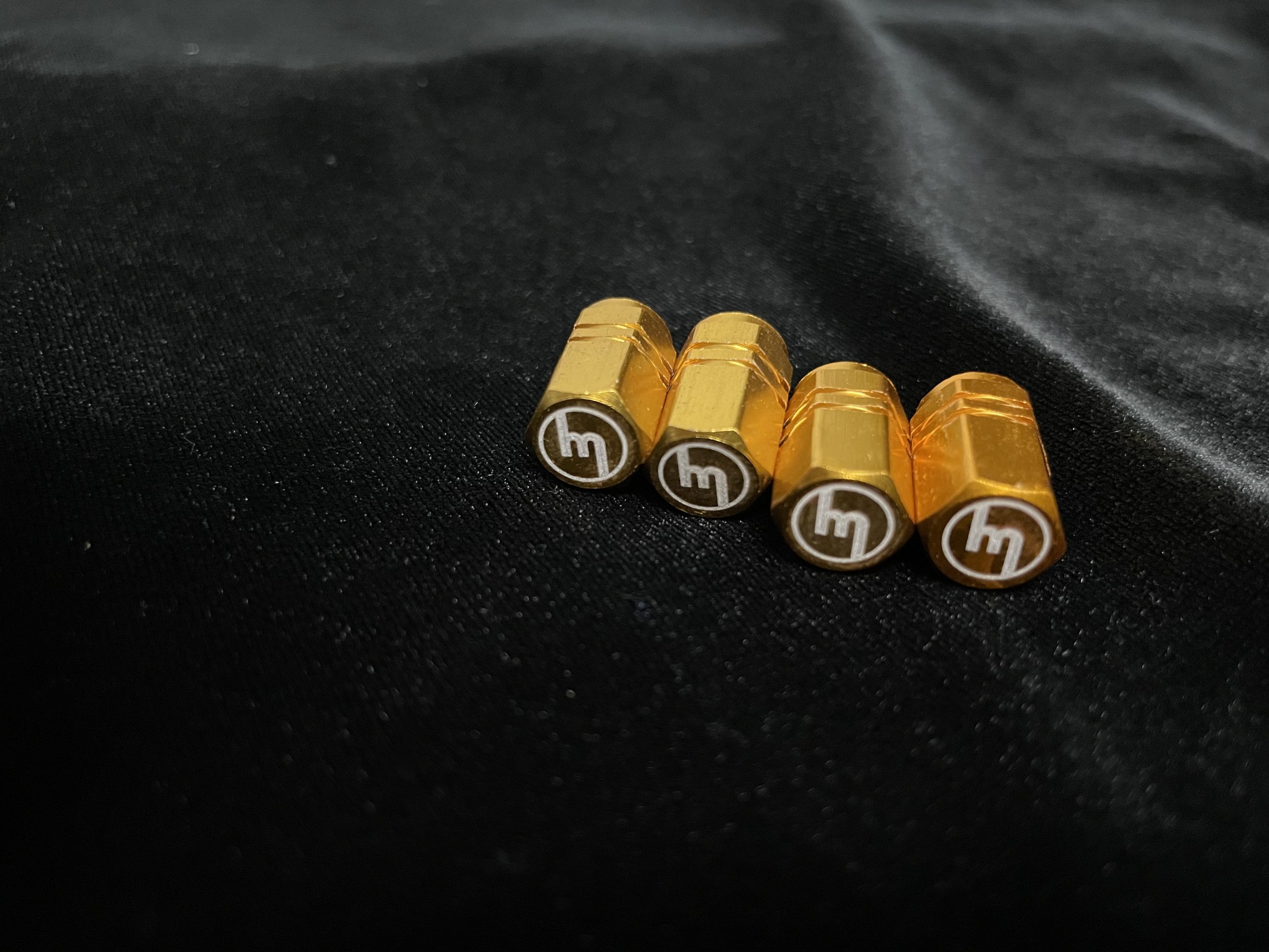 Gold Valve caps M logo