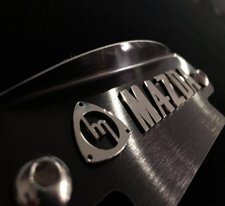 Polished M mazda logo black plate 12a