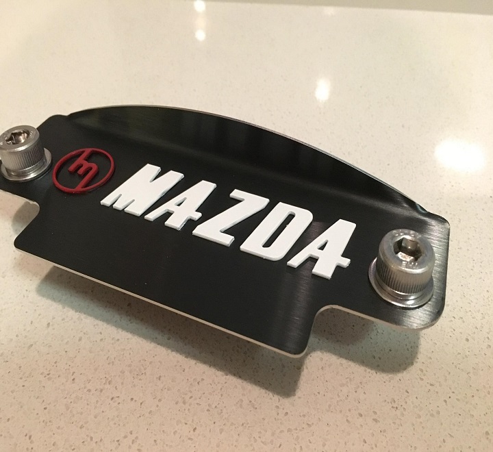Red M White Mazda black plate 12a